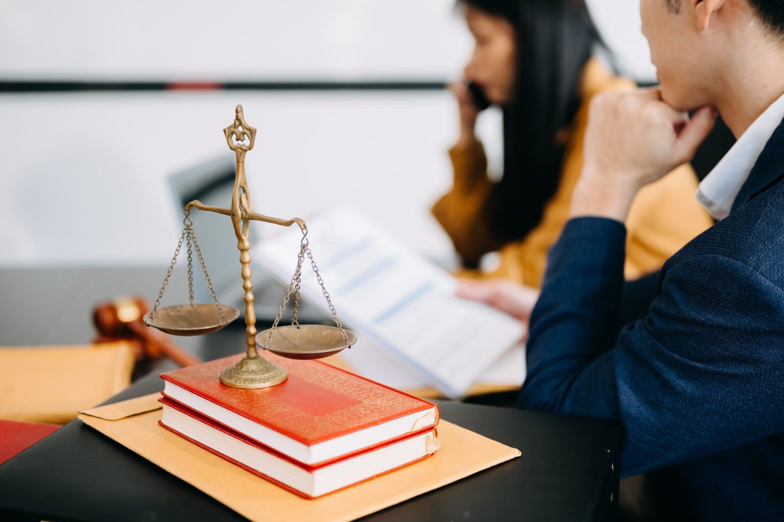 male-lawyer-in-the-office-with-brass-scale-on-wood-2024-11-01-19-25-43-utc-min